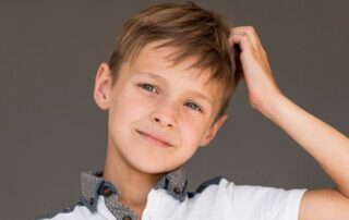 Child representing the emotional and daily life impact of alopecia in children beyond hair loss, particularly for families in Miami.